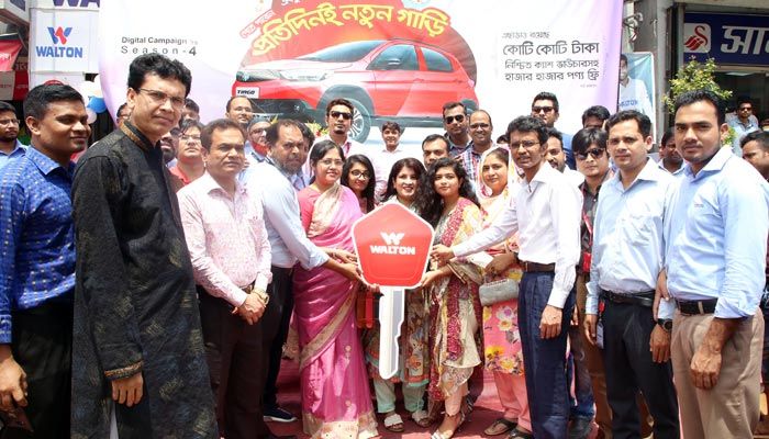 Walton Group Executive Directors Eva Rezwana, SM Zahid Hasan, Humayun Kabir and Mohammad Rayhan, is handing over the key of the new car to Tania Mesbah on Sunday last